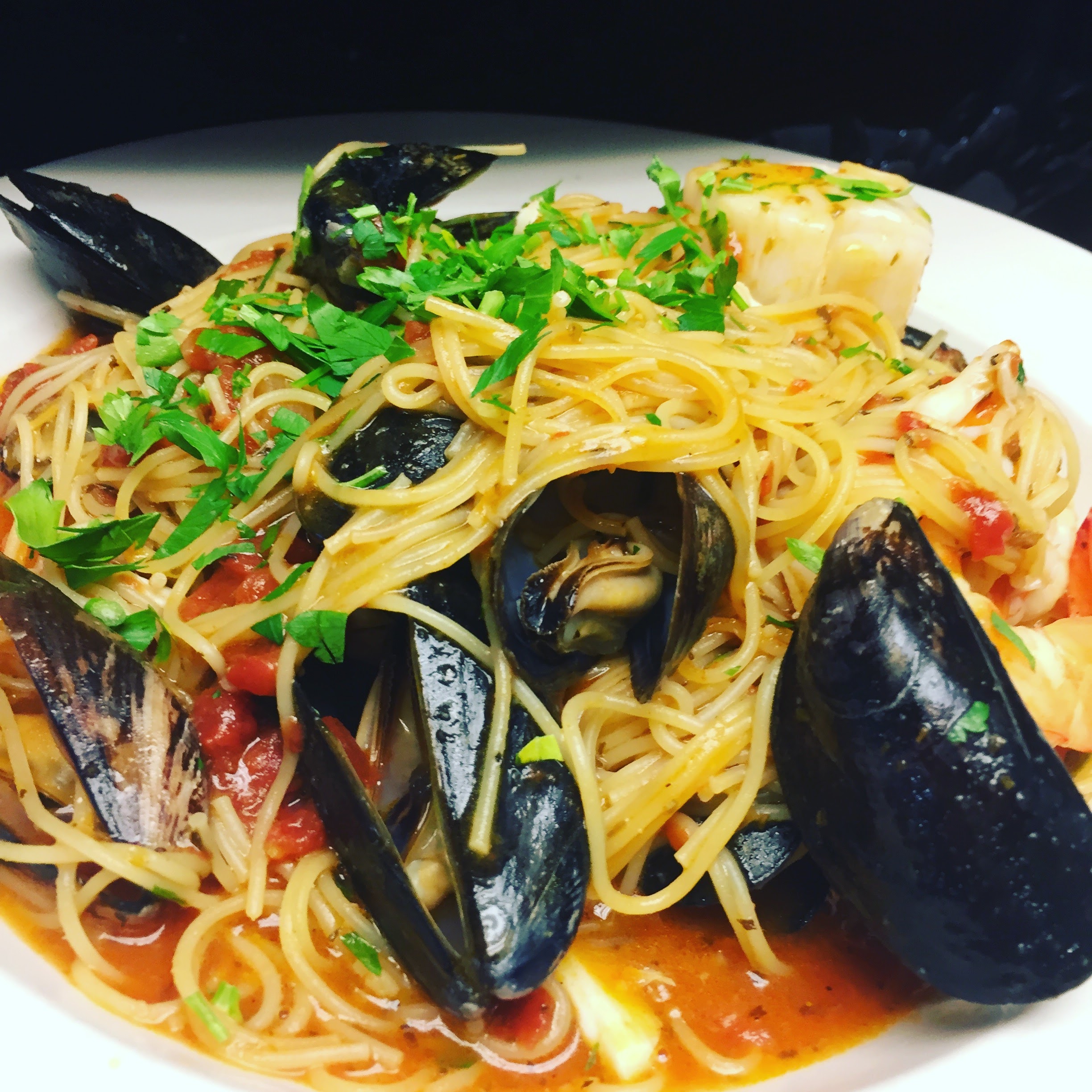 Italian-style paella with shrimp, scallops, mussels, and lump crab over angel hair pasta.