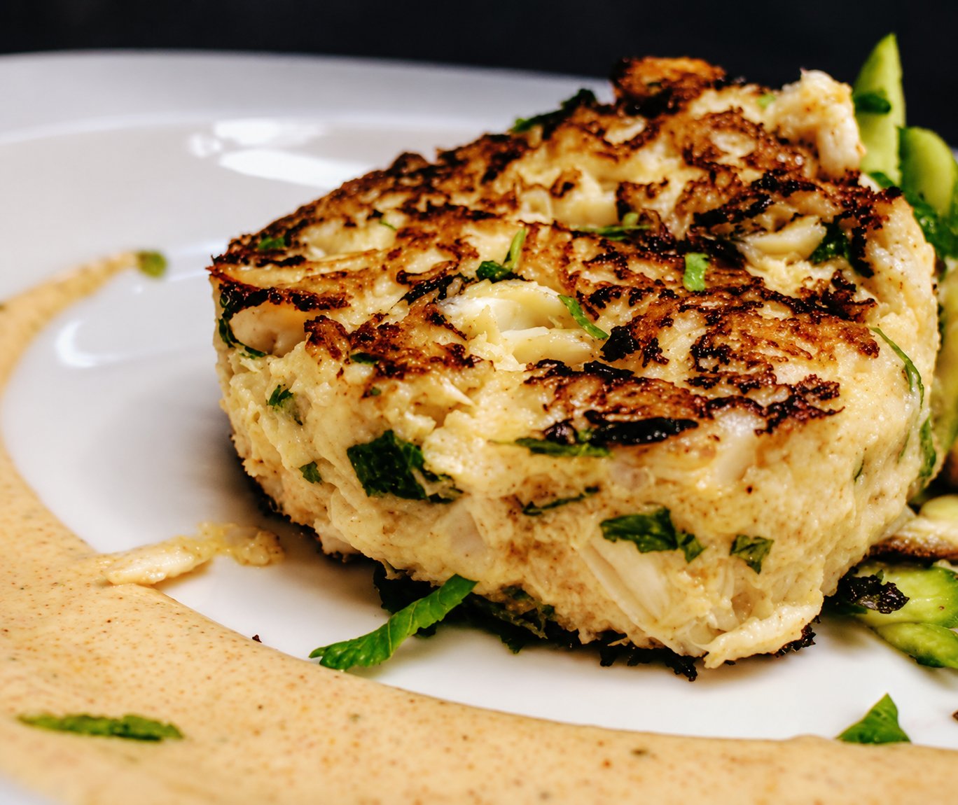 A jumbo lump crab cake, seared and plated.